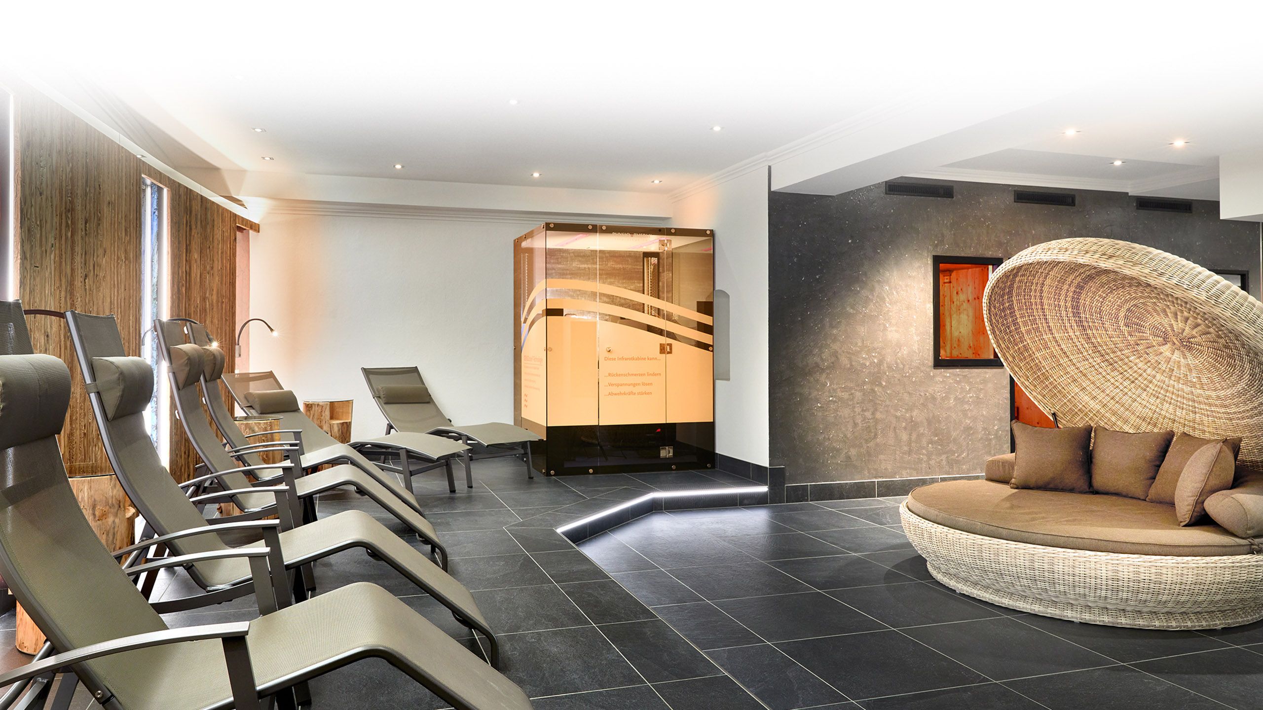 Modern relaxation room in the spa area with lounge chairs and stylish interior design