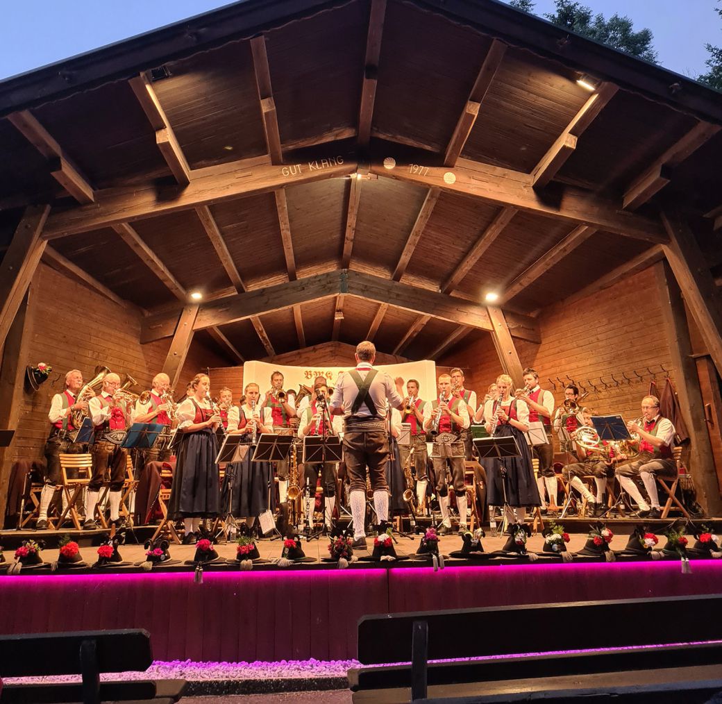 Traditional brass band in local costume performing at an evening open-air concert