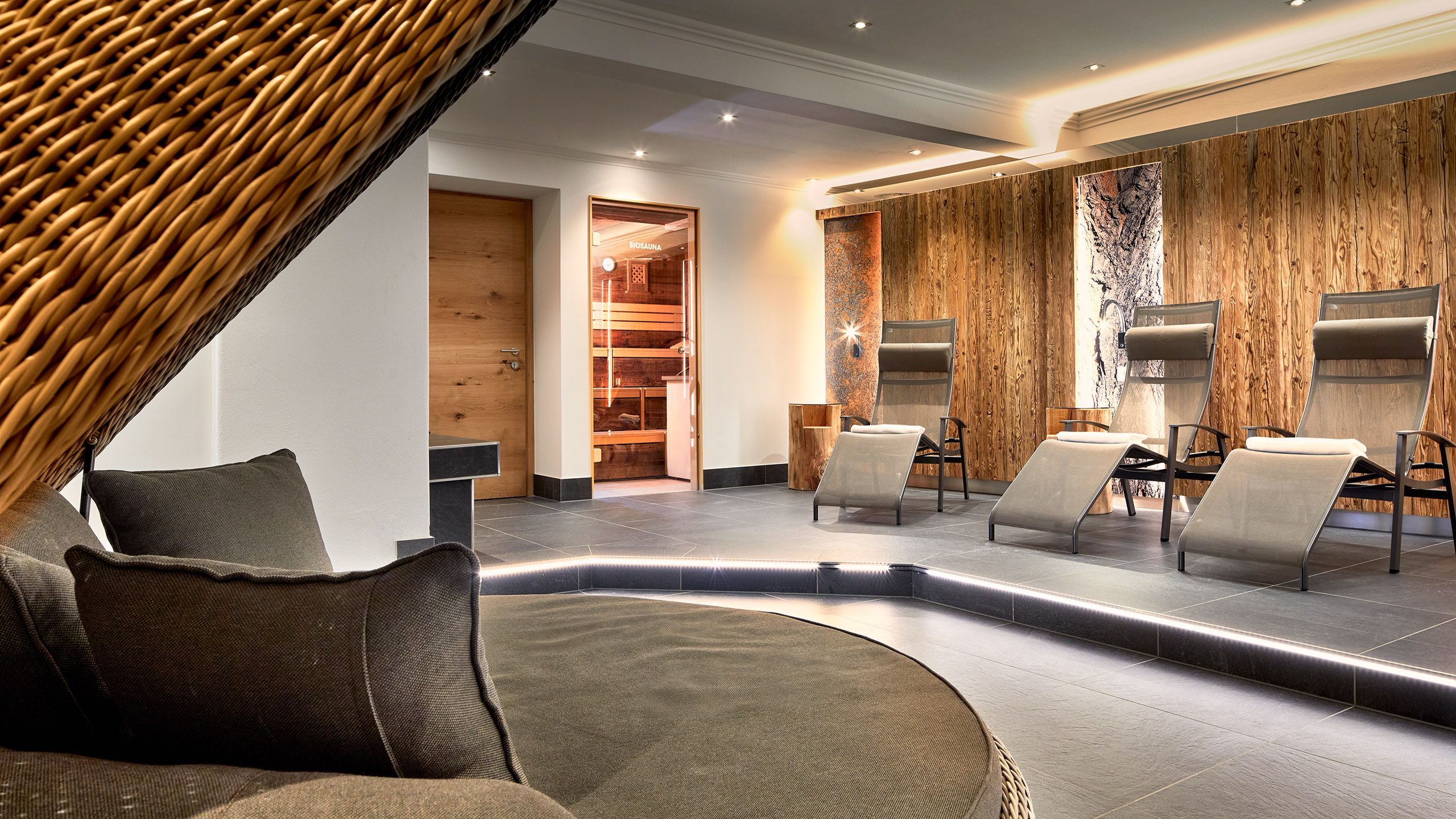 Wellness area at Hotel Platzl with relaxation loungers and modern wood design