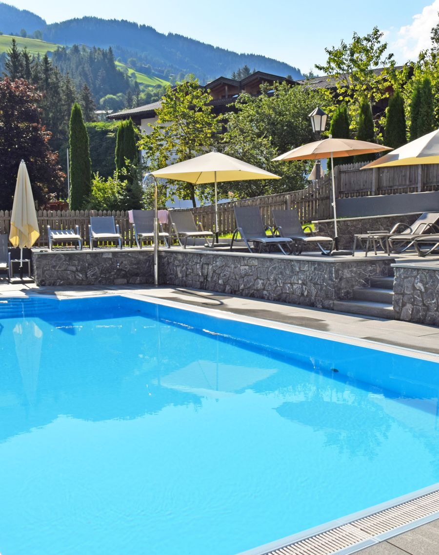Outdoor swimming pool with sun deck and panoramic Alpine mountain views