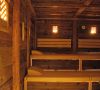 Cozy wooden sauna with warm lighting and multi-level benches
